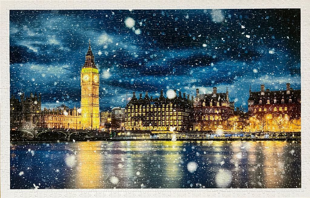 A nighttime view of the Elizabeth Tower in London during a heavy snowfall.