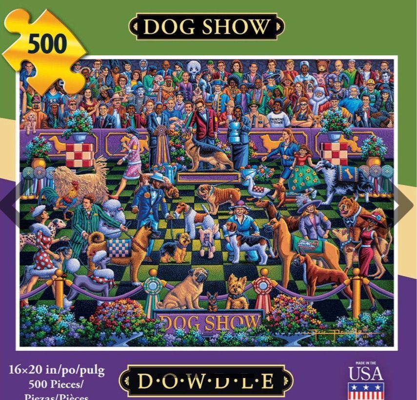 A bustling dog show scene filled with various breeds of dogs and their handlers in an indoor arena.