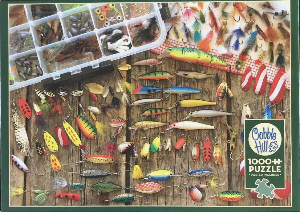 A collection of various fishing lures and tackle arranged on a wooden surface.