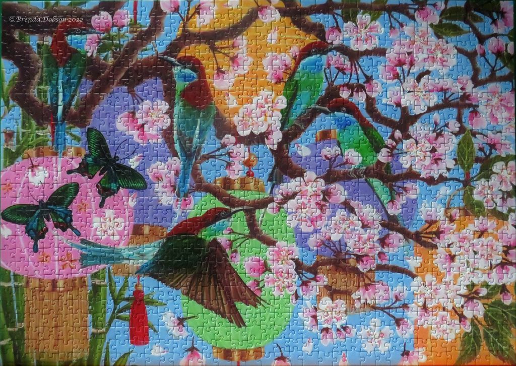 Exotic birds and butterflies amidst cherry blossoms and hanging paper lanterns.