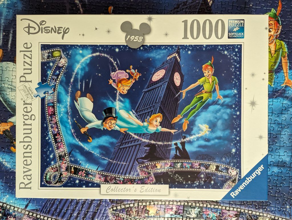 Peter Pan and the Darling children flying past Big Ben at night with a film strip border.