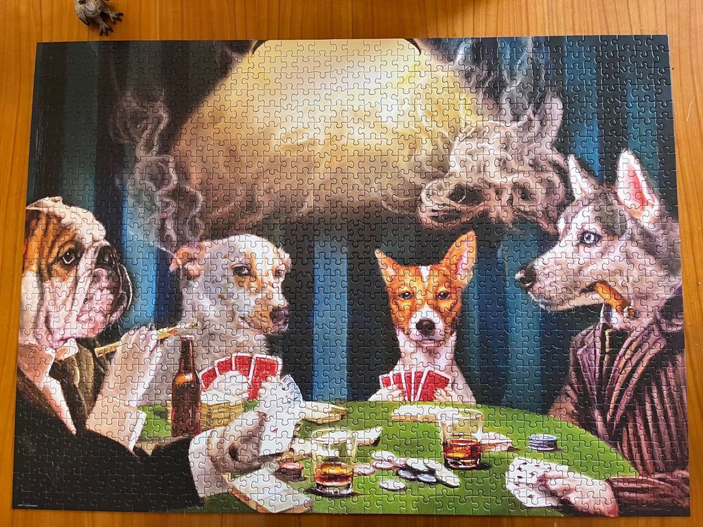 An illustration of four different dog breeds sitting at a table playing poker in a dimly lit room.