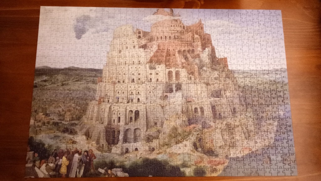 A detailed classical painting depicting the Tower of Babel with intricate architectural layers and a busy foreground.