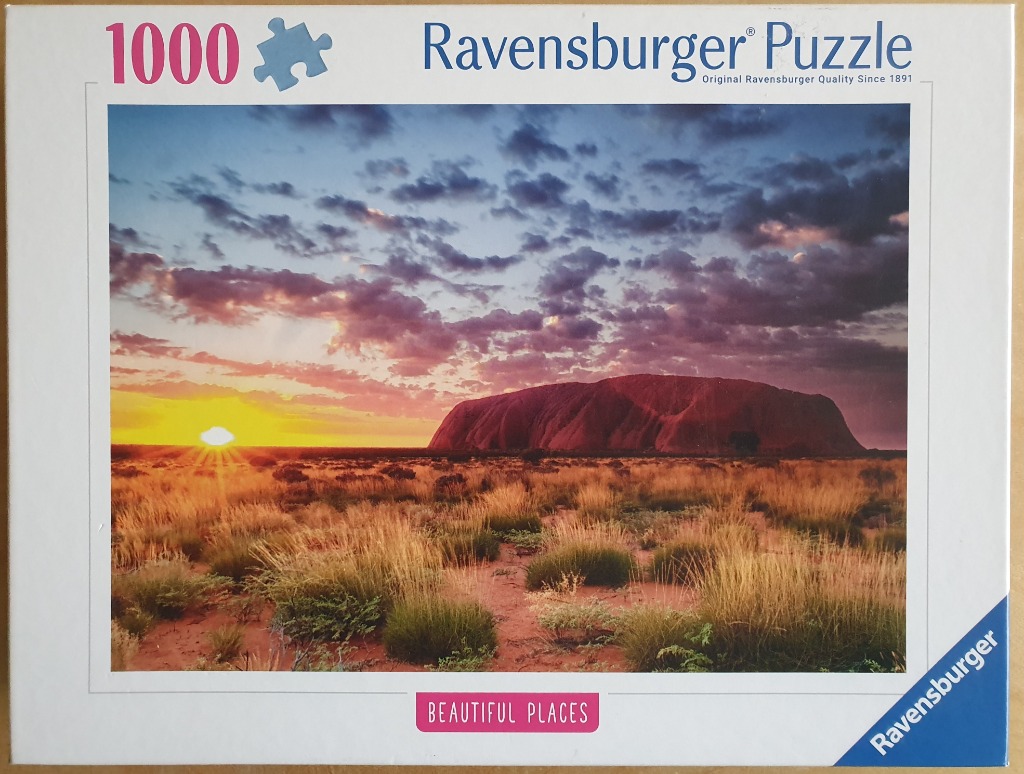 Uluru rock formation at sunrise over the Australian outback