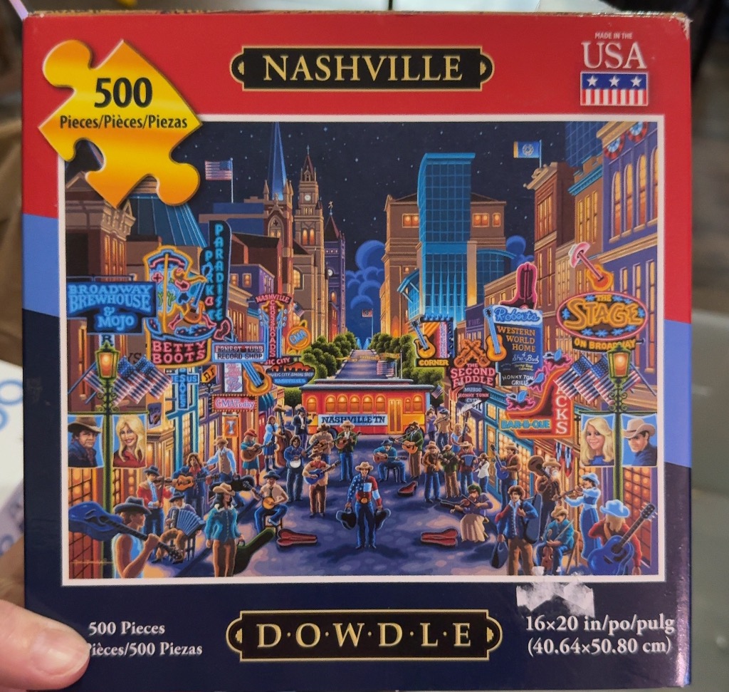 A night scene of Nashville's Broadway street filled with musicians, neon signs, and historic architecture.