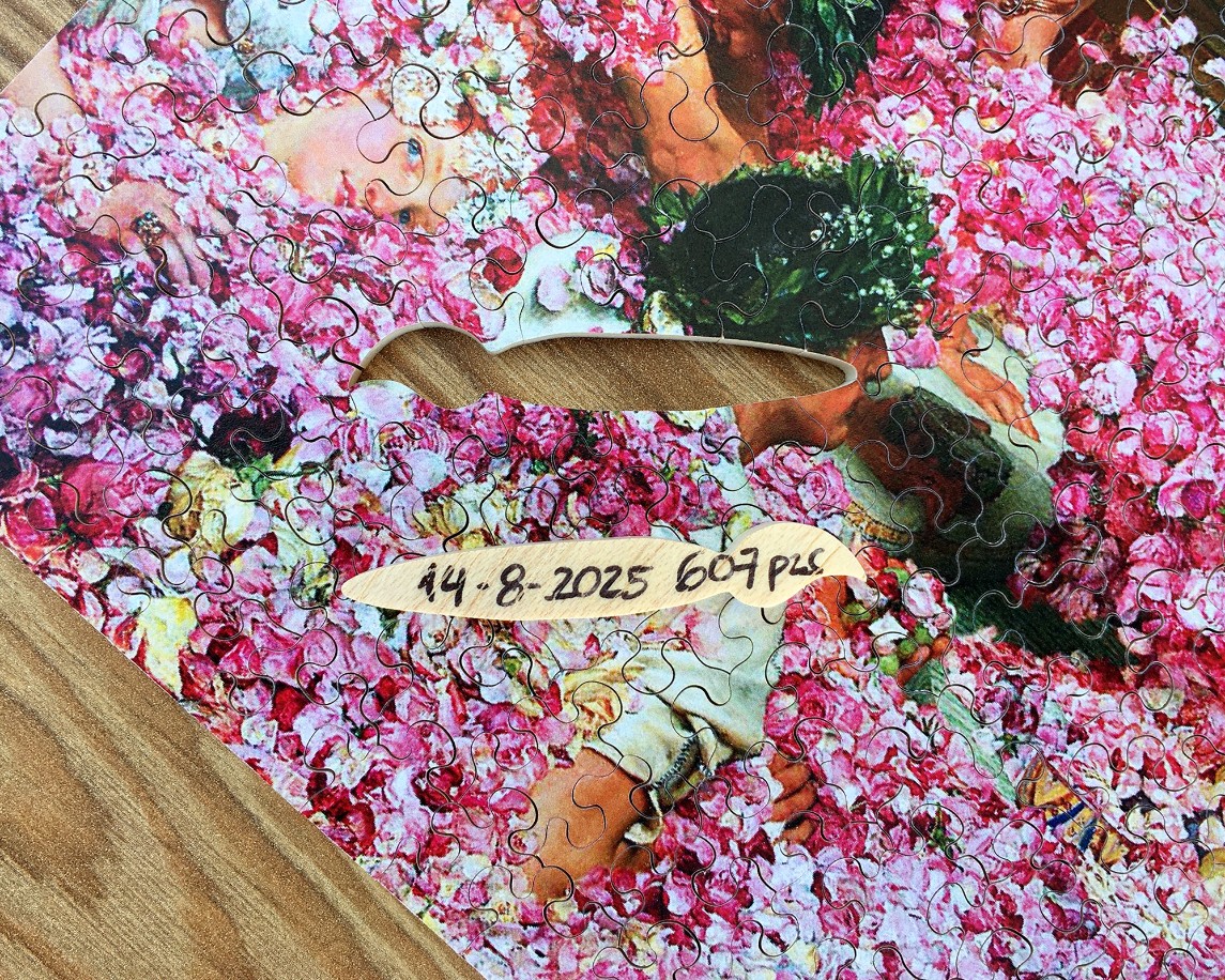 A reproduction of the painting The Roses of Heliogabalus showing figures buried in pink rose petals.