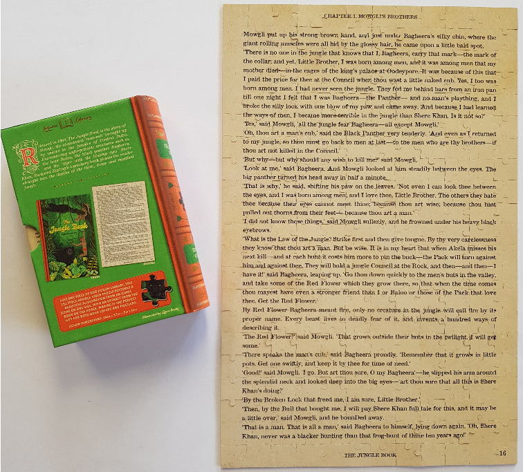 A page of text from The Jungle Book beside its green book-shaped container.