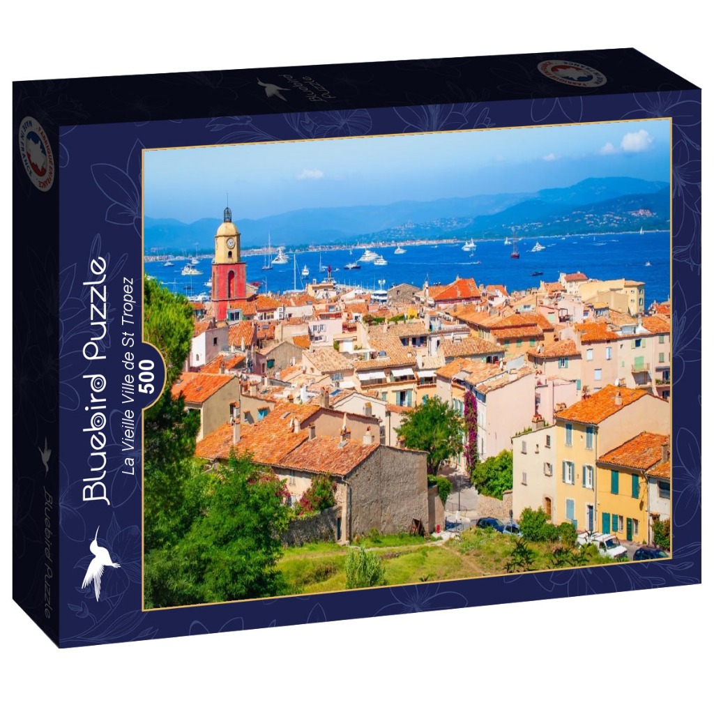 A photograph of the old town of Saint-Tropez overlooking a blue harbor with terracotta roofs under a sunny sky.