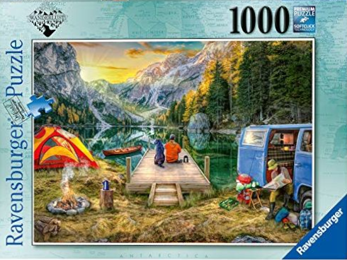 A person and dog sit on a wooden dock overlooking a mountain lake at sunset, with a camper van and tent nearby.