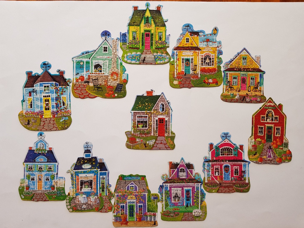 A collection of eleven charming, illustrated cottage-style houses featuring autumn decor and garden scenes.