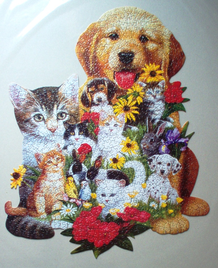 A group of dogs, kittens, and bunnies nestled among colorful flowers in a shaped illustration.