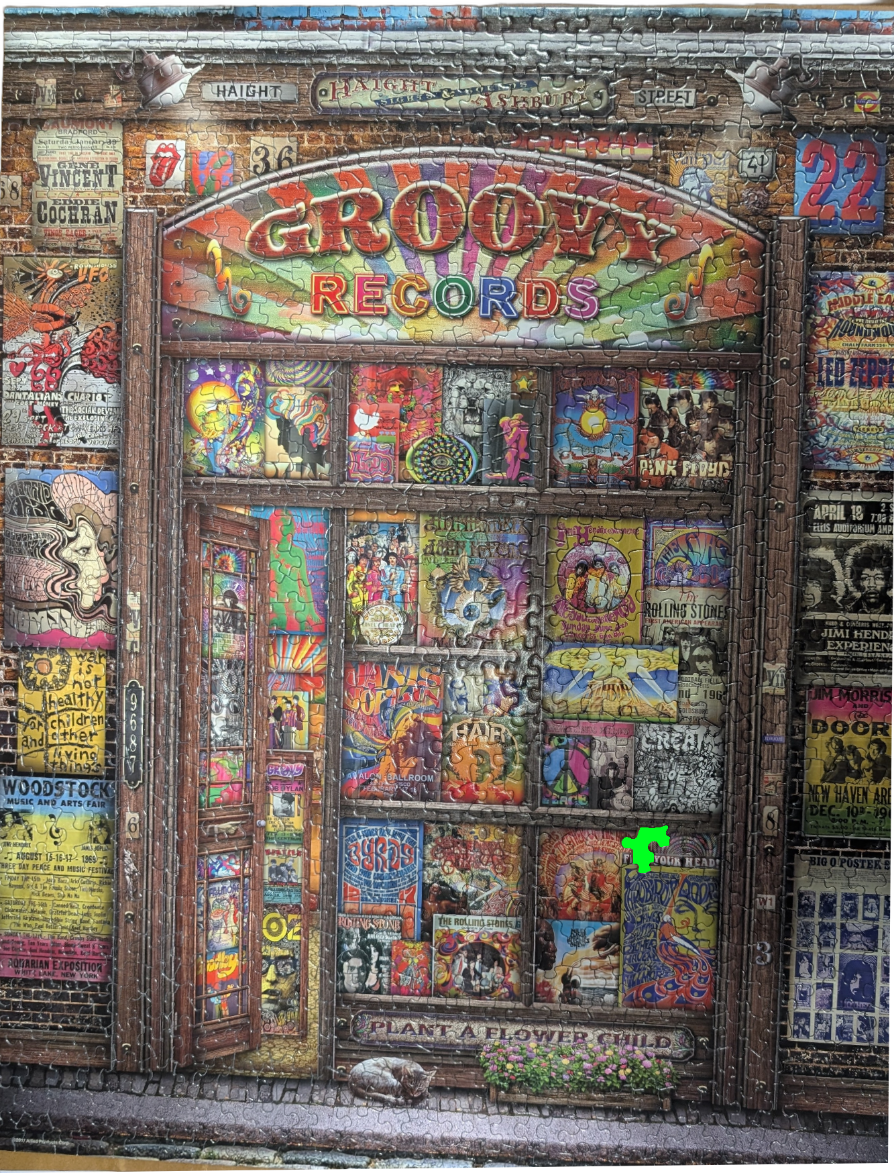 A vintage storefront of Groovy Records covered in psychedelic music posters and album art.