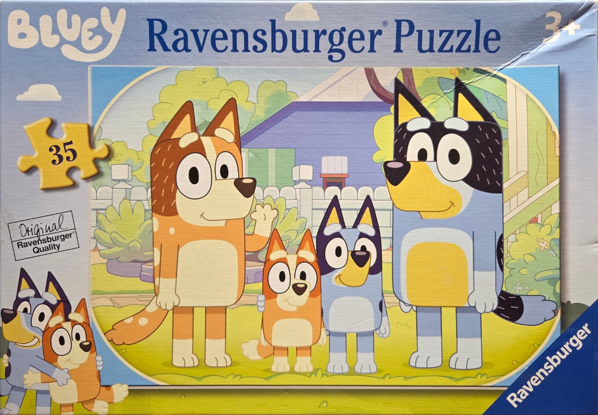 A cartoon scene featuring a family of four stylized blue and red heeler dogs standing in a suburban yard.