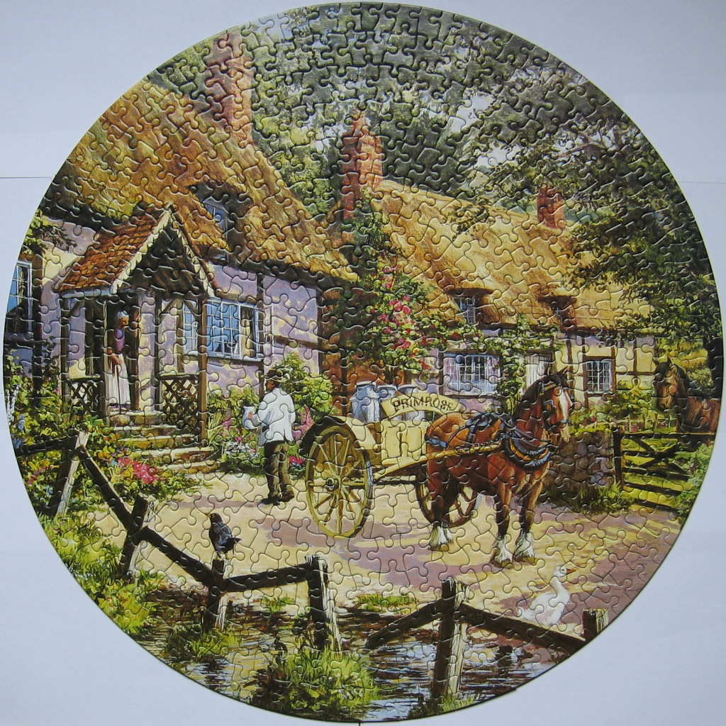 A rural countryside scene featuring a thatched cottage, a horse-drawn milk cart, and a small stream in a round frame.