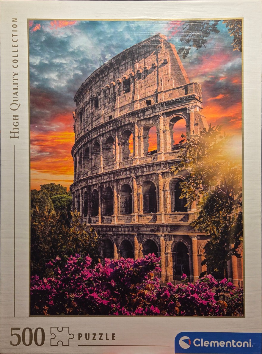 The Colosseum in Rome against a vibrant sunset with purple flowers in the foreground.