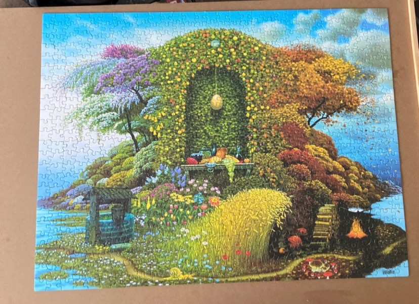 An illustration of a magical, four-season hillside containing a stone grotto, a well, and a campfire.