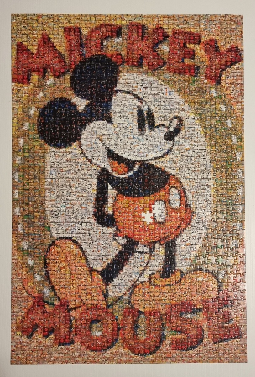 A photo mosaic of Mickey Mouse comprised of hundreds of small scenes from classic animations.