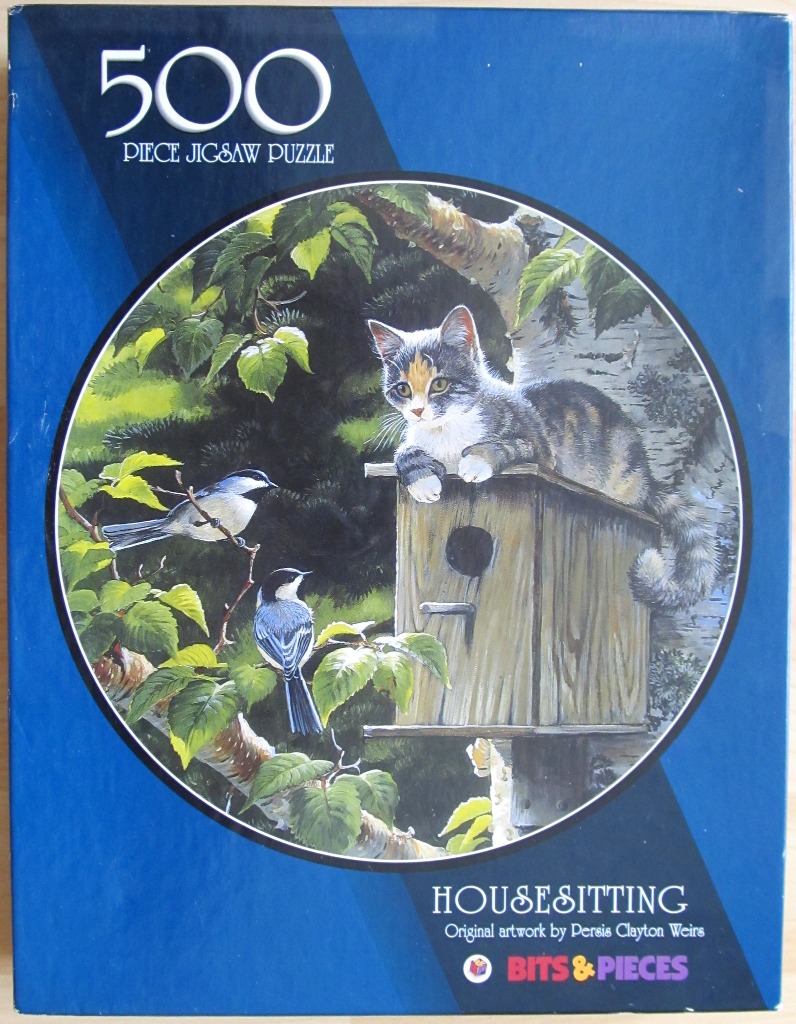 A painting of a calico kitten perched atop a wooden birdhouse with two chickadees nearby in a leafy tree.