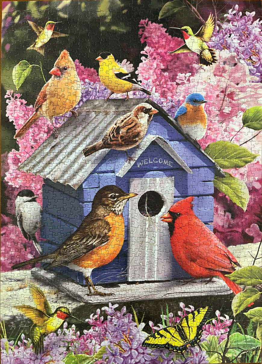 A blue birdhouse surrounded by various birds, butterflies, and purple lilac flowers.