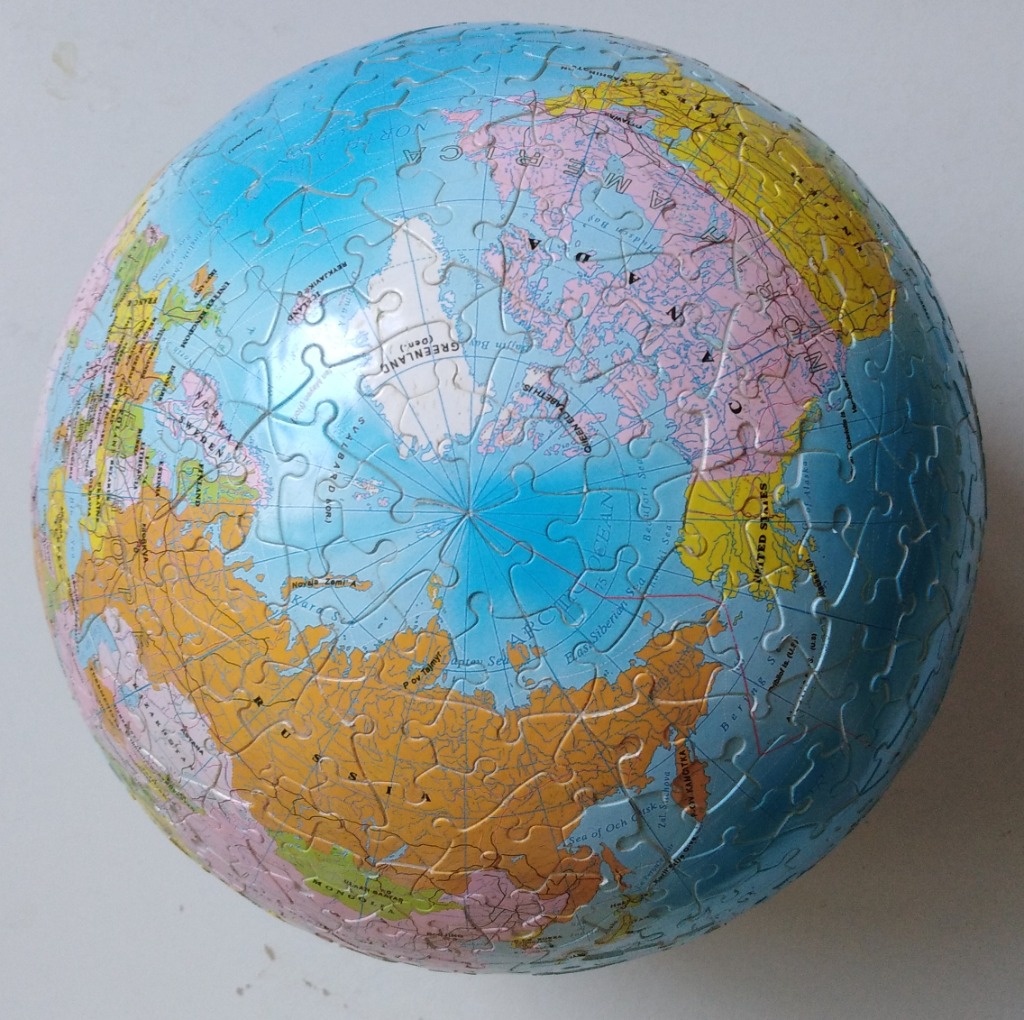 A spherical globe showing the Arctic region and surrounding continents with colourful political boundaries.