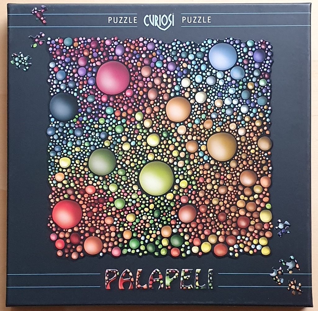 A dense cluster of colorful, glossy spheres of various sizes set against a solid black background.