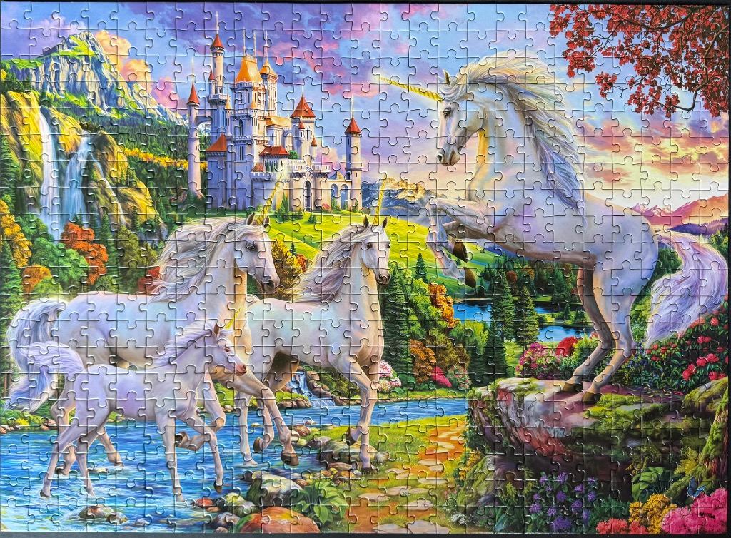 A fantasy scene featuring three white unicorns, a magical castle, and a waterfall in a vibrant, sunlit landscape.