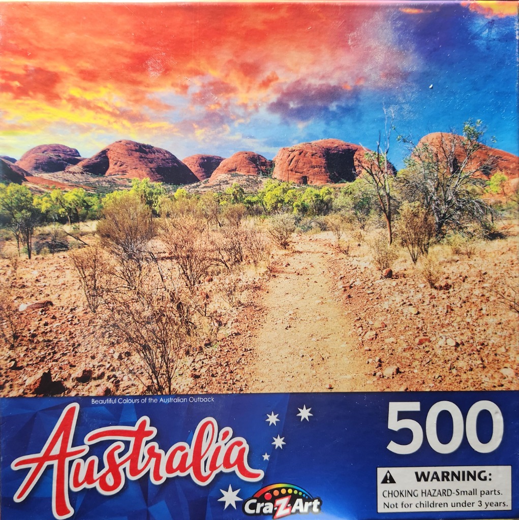The rugged, red-rock domes of Kata Tjuta in the Australian Outback under a vibrant sunset sky.
