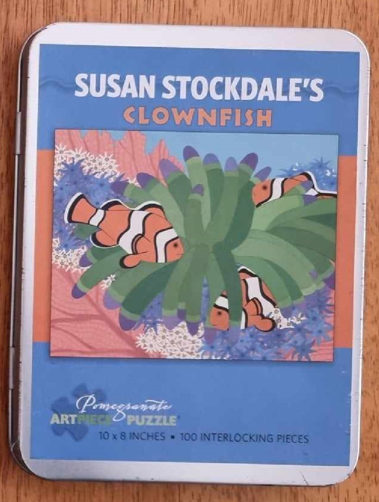 Illustration of orange and white clownfish swimming among green and purple sea anemones.