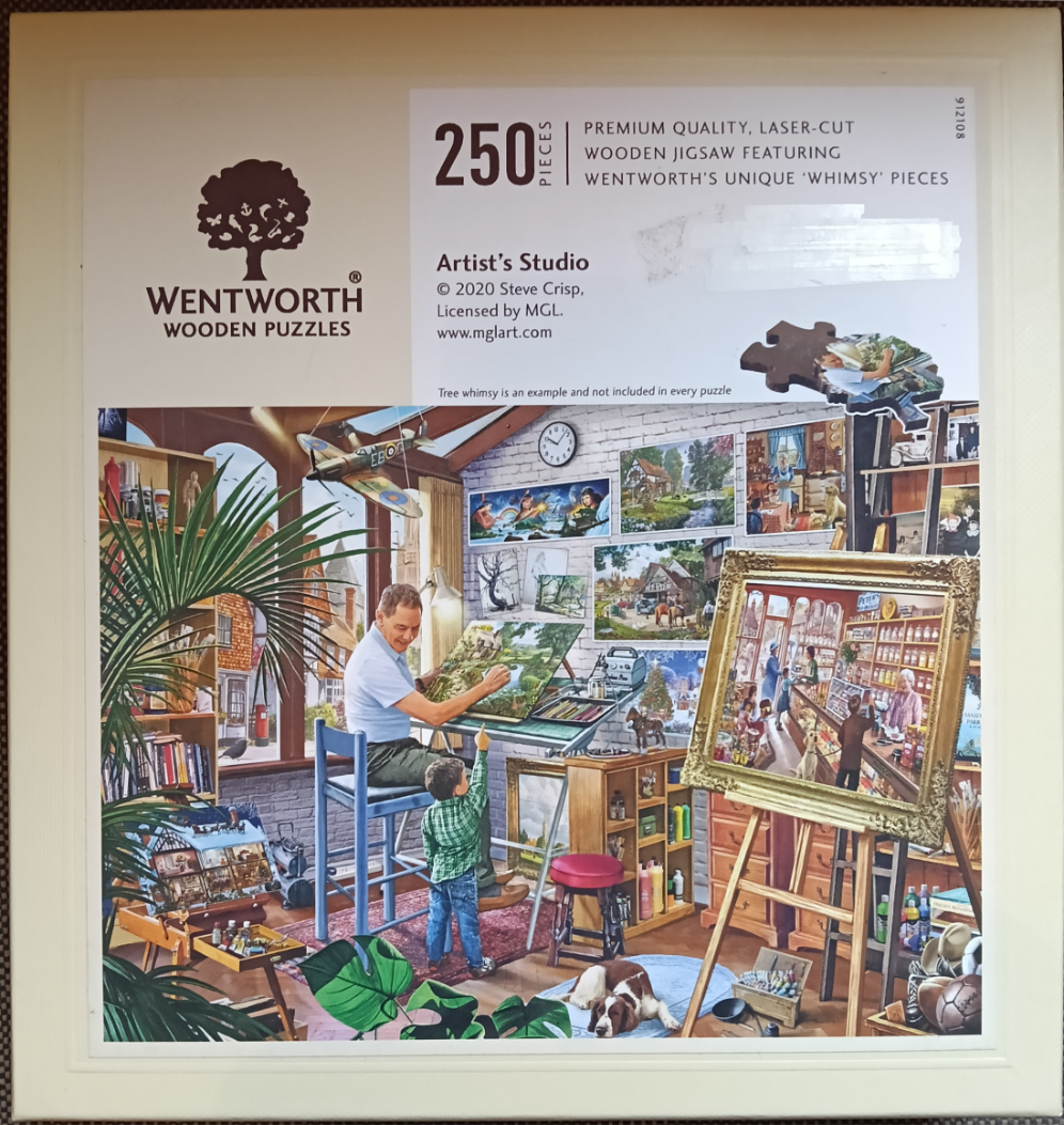 An artist in a studio with a young child pointing at a landscape painting on an easel, surrounded by art supplies.