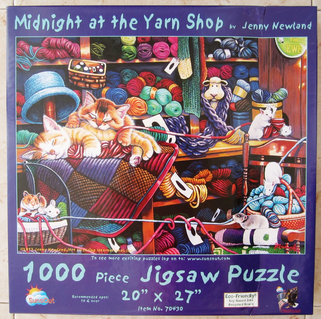 Two ginger kittens sleeping on a patchwork quilt inside a cozy yarn shop with mice and colorful skeins of yarn.
