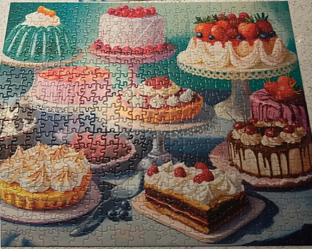 An illustration of various cakes and pastries arranged on a tabletop.