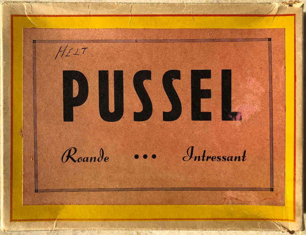 Vintage graphic design with the word PUSSEL in bold black letters on a tan background.