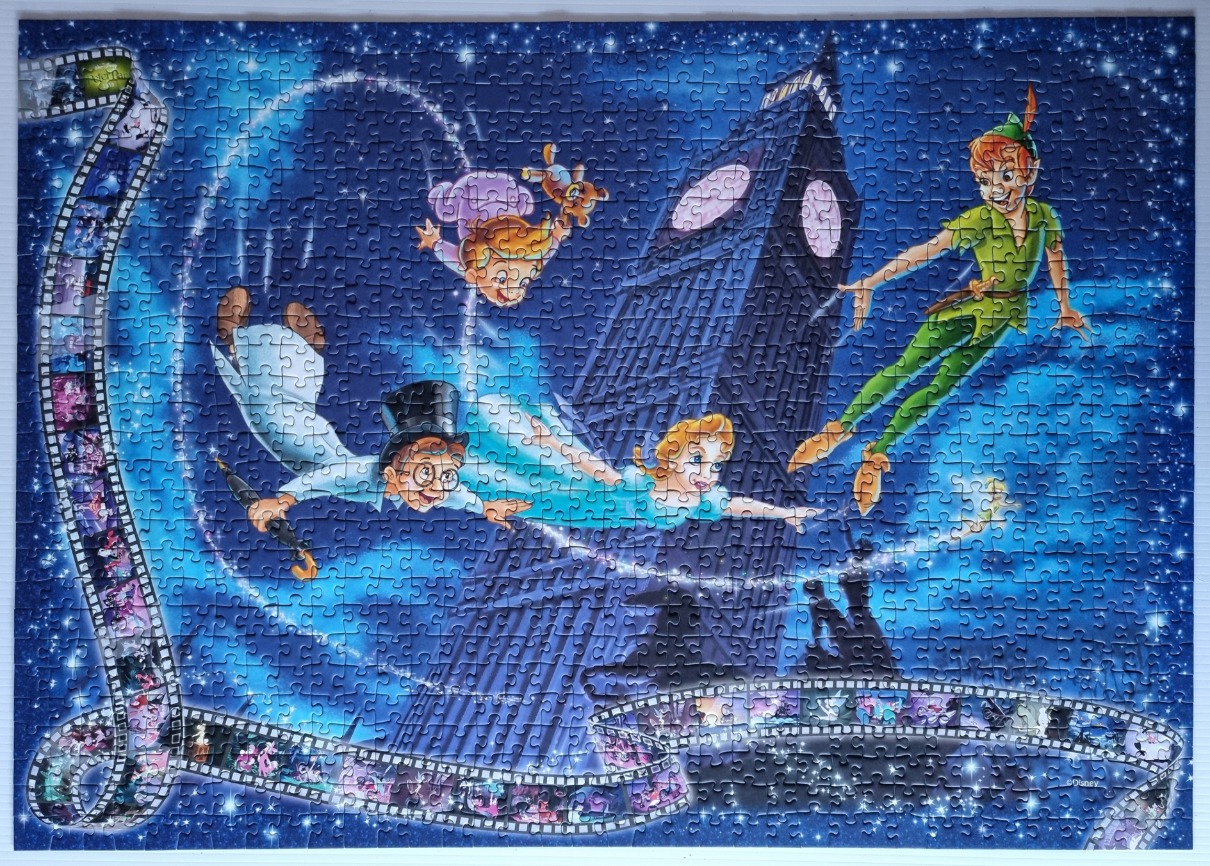 Peter Pan, Wendy, John, and Michael flying above Big Ben with a film strip frame.