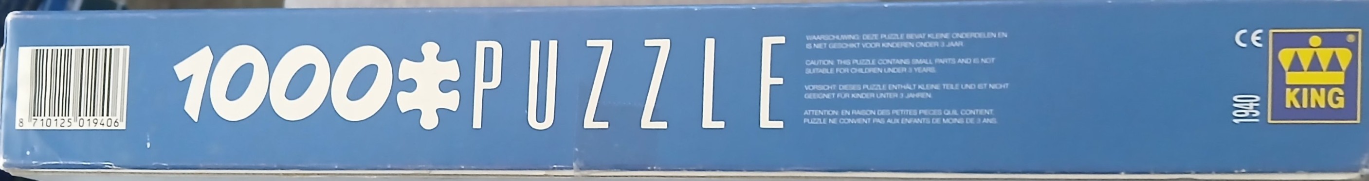 Side of a blue box labeled 1000 PUZZLE with a barcode and manufacturer logo.