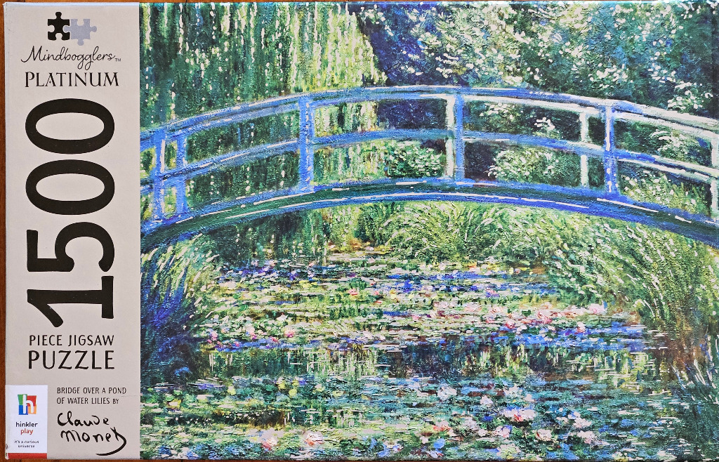 Impressionist painting of a Japanese-style arched bridge over a lily pond by Claude Monet.
