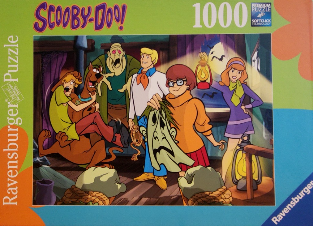 The Scooby-Doo gang unmasking a monster in a spooky, dimly lit room.