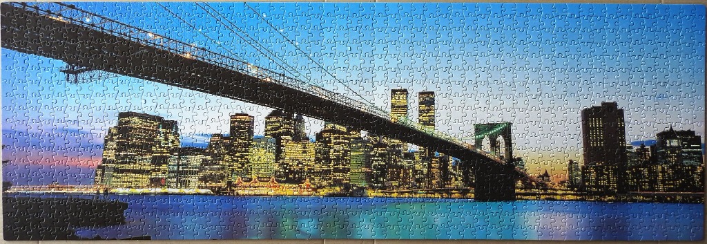 Panoramic view of the Brooklyn Bridge with the New York City skyline at dusk.