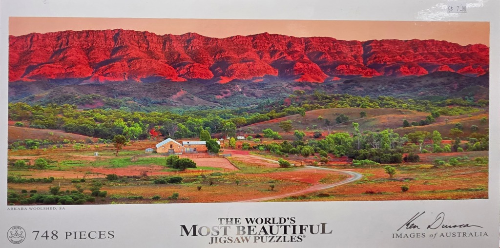 Panoramic view of the Arkaba Woolshed in South Australia at sunset with glowing red mountain ranges in the background.