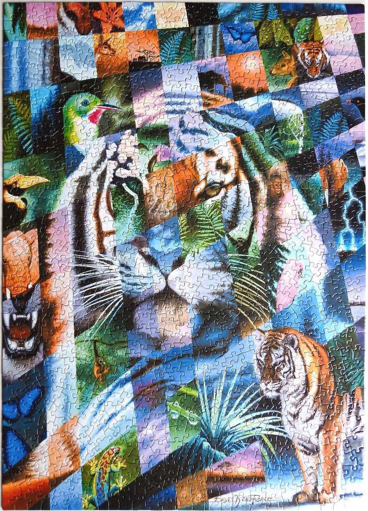 A collage of various animal portraits arranged in a grid-like mosaic forming the face of a tiger.