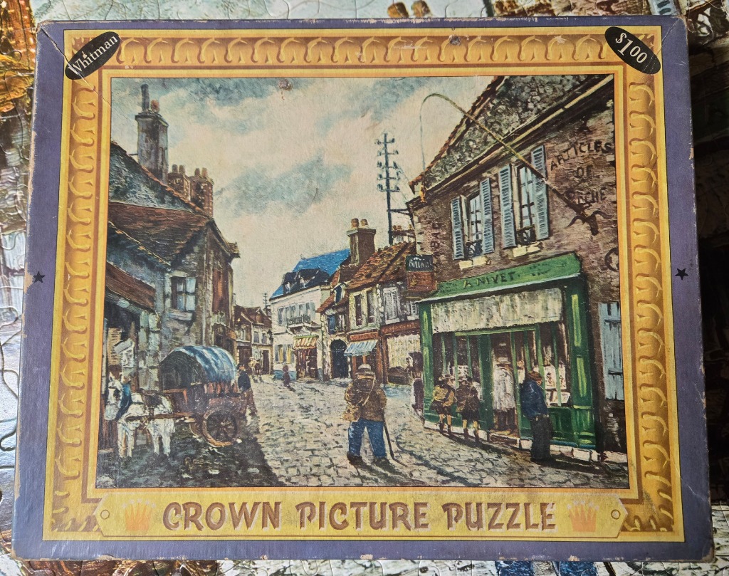 Impressionistic painting of a cobblestone village street with a horse-drawn cart and storefronts.