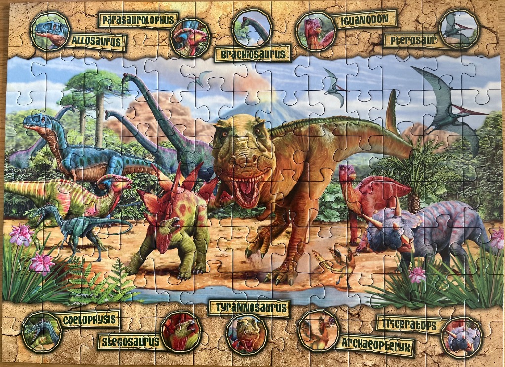 A prehistoric landscape featuring a variety of dinosaurs and flying reptiles with labels in circular frames.