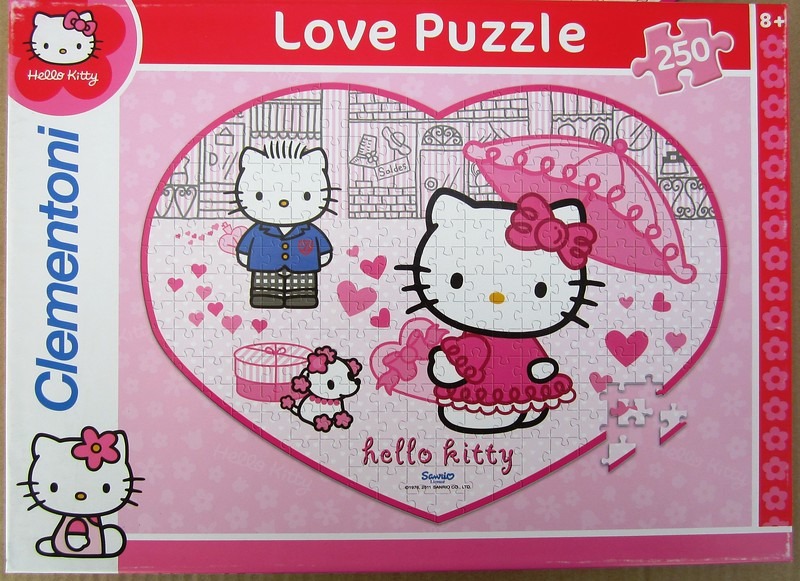 Hello Kitty and a friend in a pink heart-shaped frame with hearts and a small dog