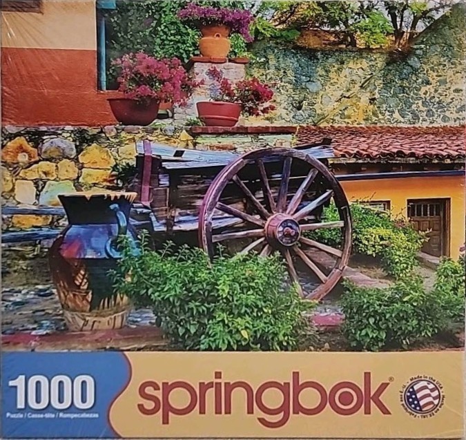 A rustic courtyard scene with a wooden wagon wheel, terracotta pots with flowers, and a stone wall.