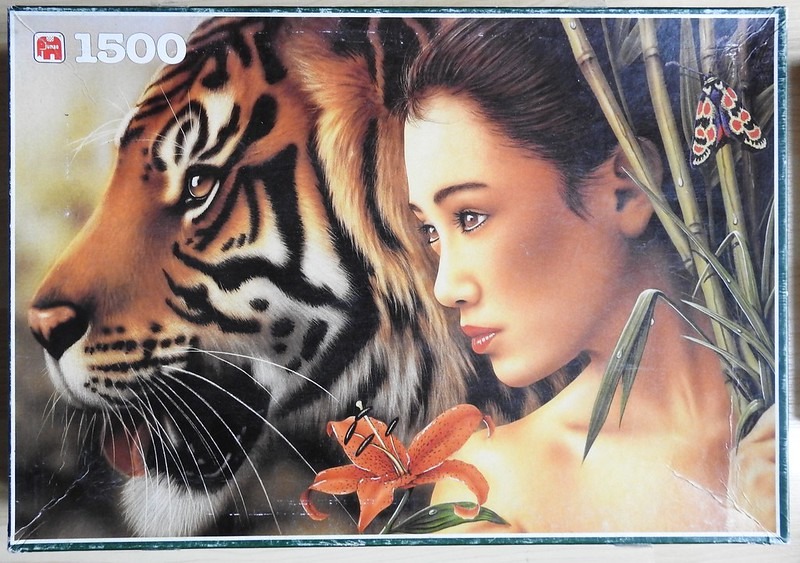 A side-profile illustration of a tiger and a woman with a tiger lily and butterfly.