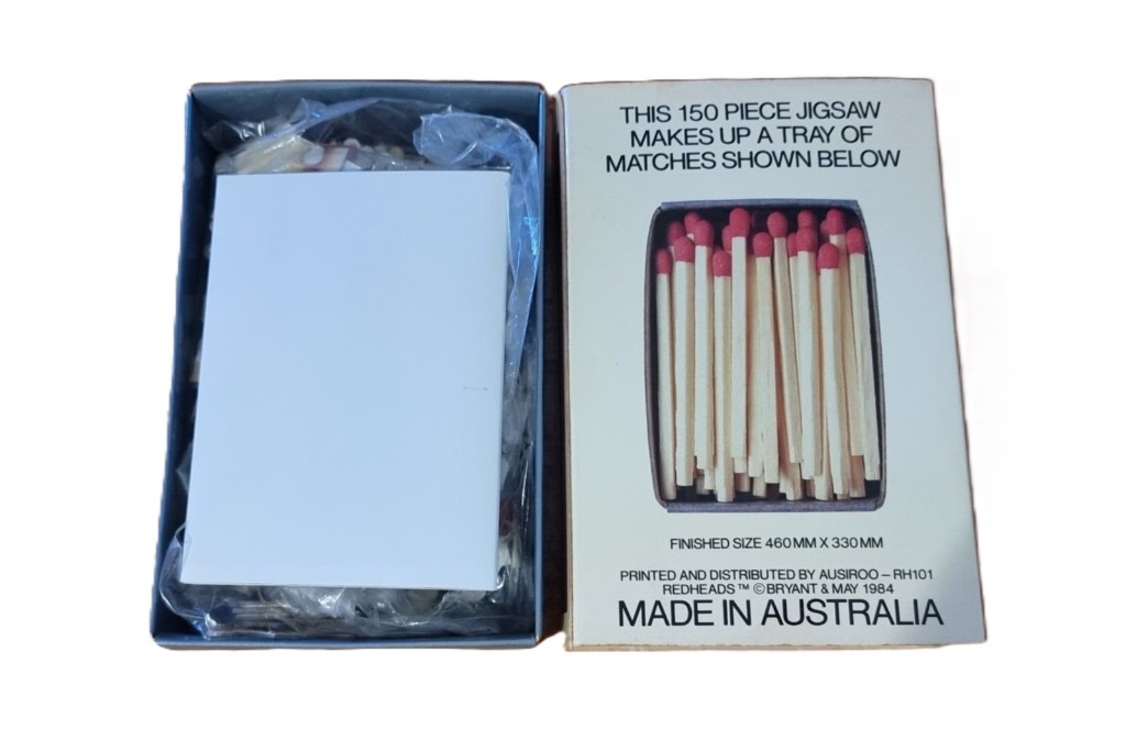 A close-up illustration of a small tray filled with wooden matchsticks with red tips on a white background.
