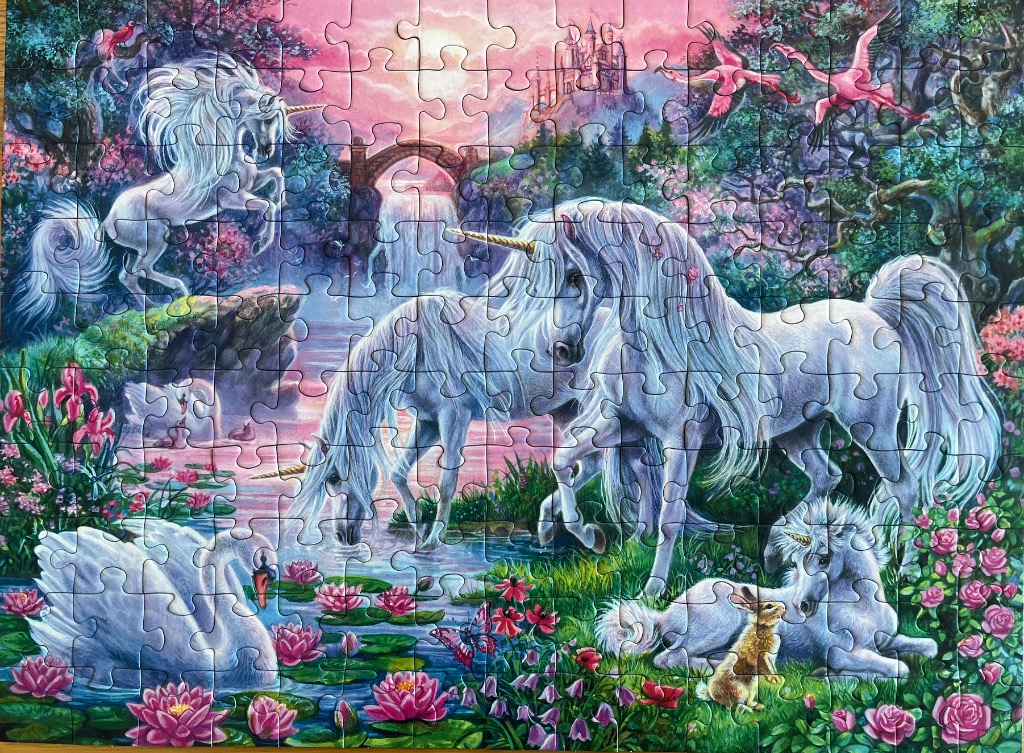 A fantasy illustration of multiple white unicorns by a magical pond with flowers, swans, and a distant castle.