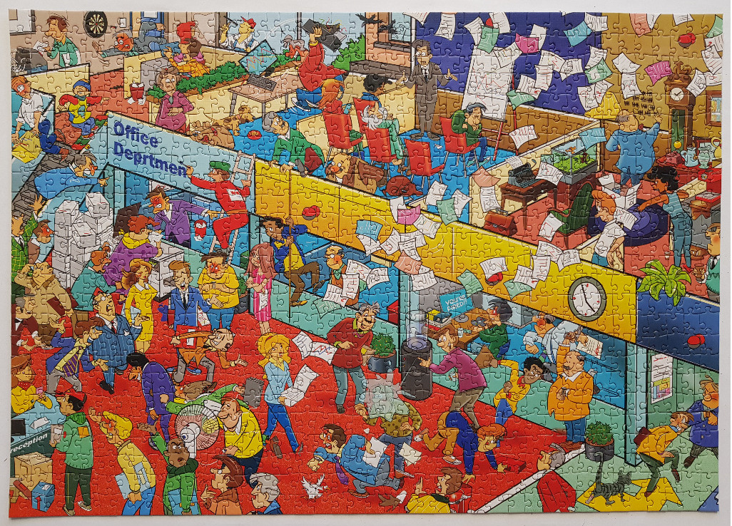 A humorous, chaotic cartoon scene of a busy office department with many people and papers flying through the air.