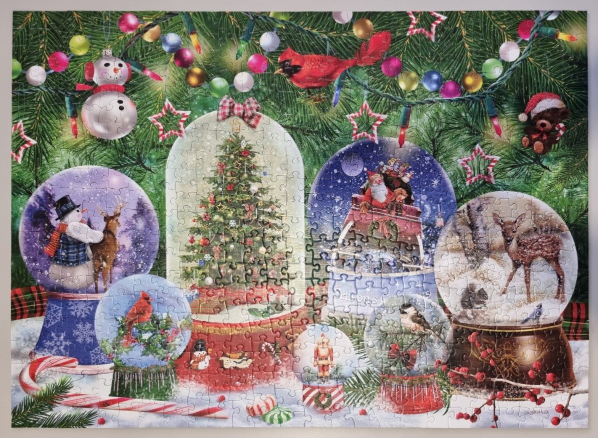 A festive illustration featuring multiple snow globes of various sizes decorated with classic Christmas themes.