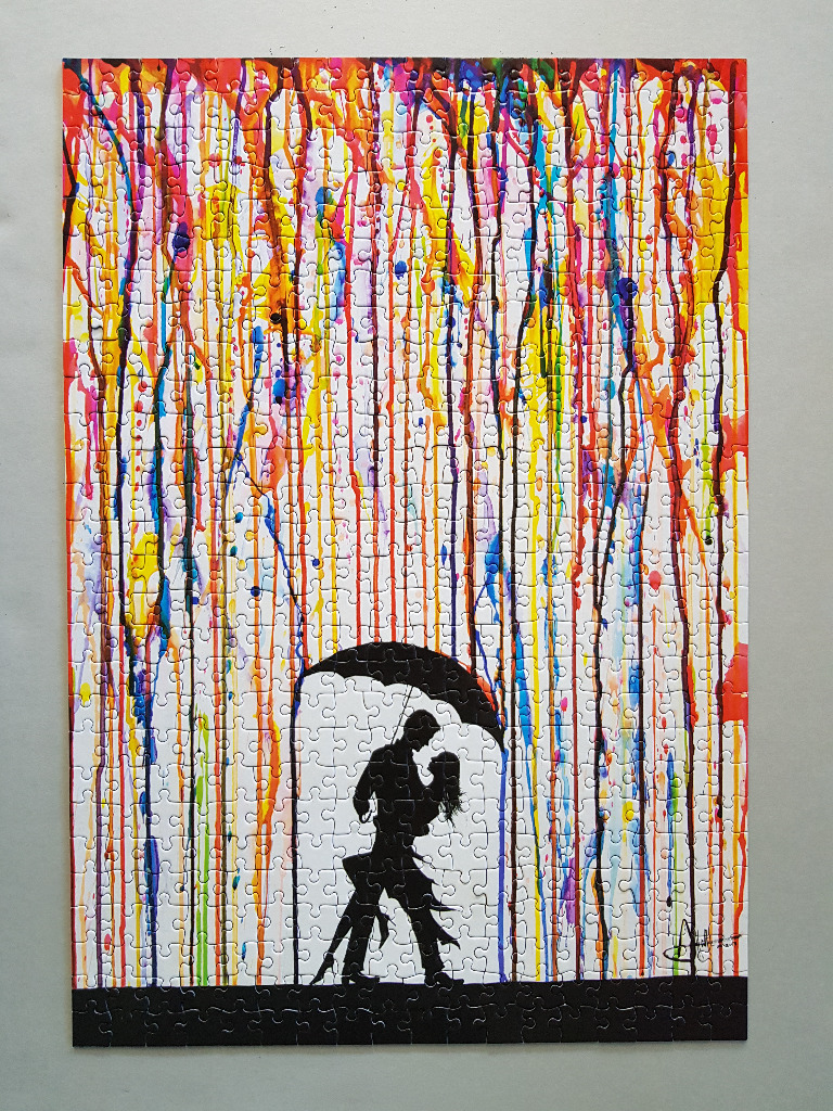 Silhouetted couple dancing under an umbrella against a backdrop of colorful vertical paint drips.