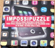 A smartphone surrounded by an array of colorful app icons on a black background.